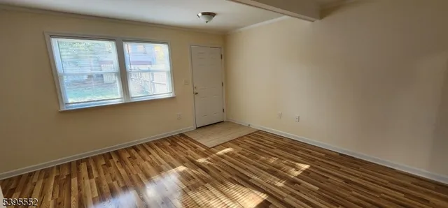a view of a room with wooden floor and closet