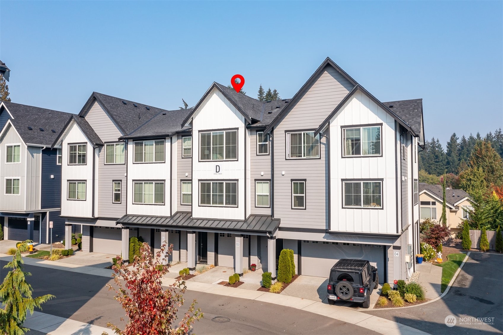 1621 Seattle Hill Road, Unit D3 Bothell, WA 98012 - Photo 1 of 25 a view of a white house with large windows and a small yard