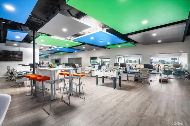 a living room with lots of furniture and a large window