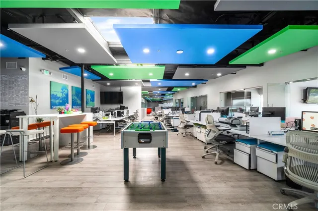 a dining room with furniture and a floor to ceiling window