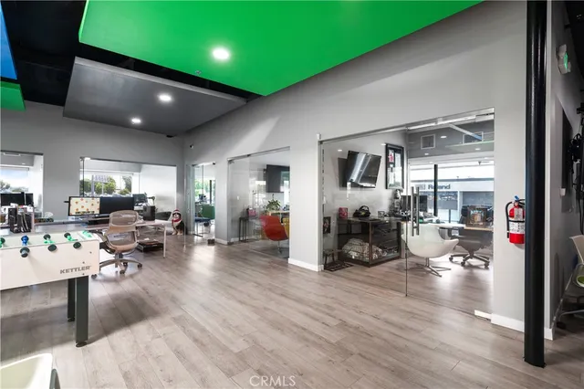 a view of a workspace with furniture and a window