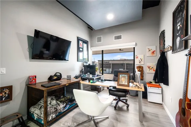 a living room with lots of furniture and kitchen view