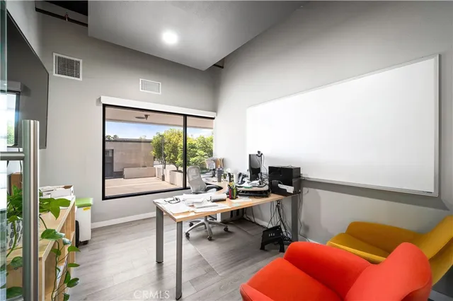 a living room with furniture a flat screen tv and a table