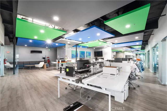 a kitchen with a table chairs refrigerator and cabinets