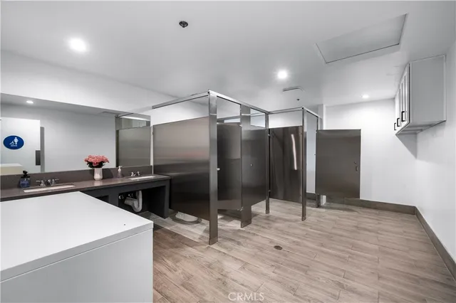 a view of a kitchen with a refrigerator and a stove top oven