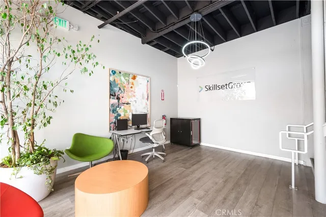 a living room with furniture a flat screen tv and floor to ceiling window