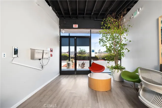 a living room with lots of furniture and kitchen view