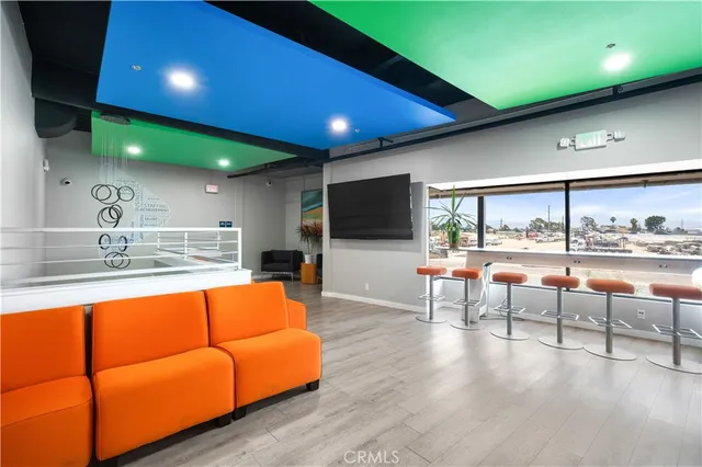 a living room with furniture a rug and a large window