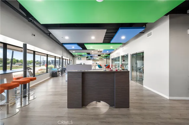 a living room with patio furniture and a large window