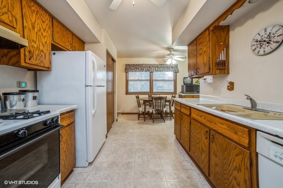 1208 Ridgeway Drive Elgin, IL 60123 - Photo 4 of 10 a kitchen with stainless steel appliances granite countertop a stove a sink and a refrigerator