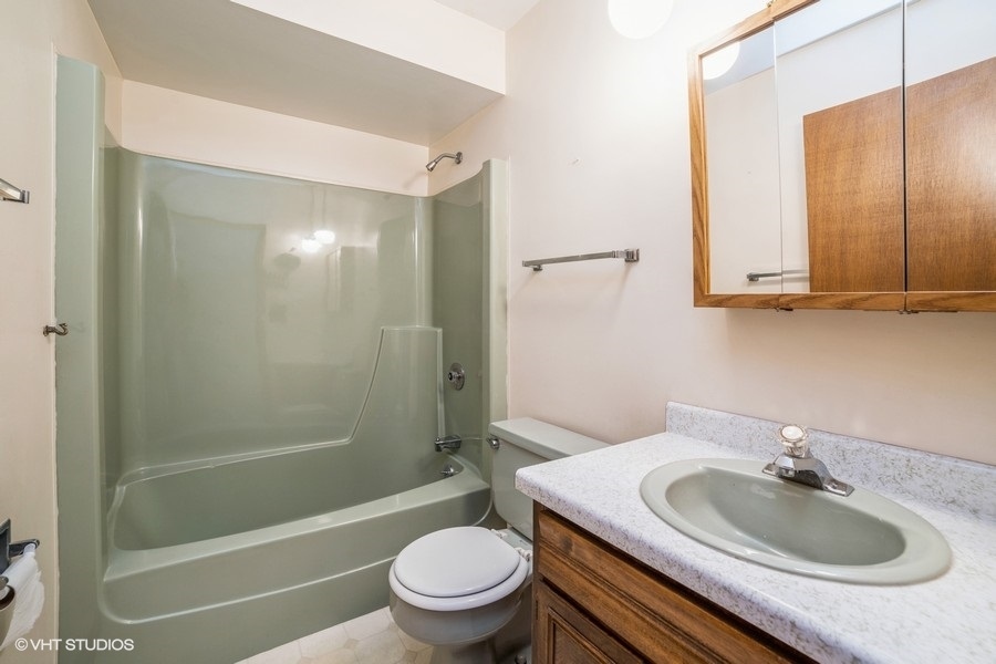1208 Ridgeway Drive Elgin, IL 60123 - Photo 9 of 10 a bathroom with a sink toilet and shower