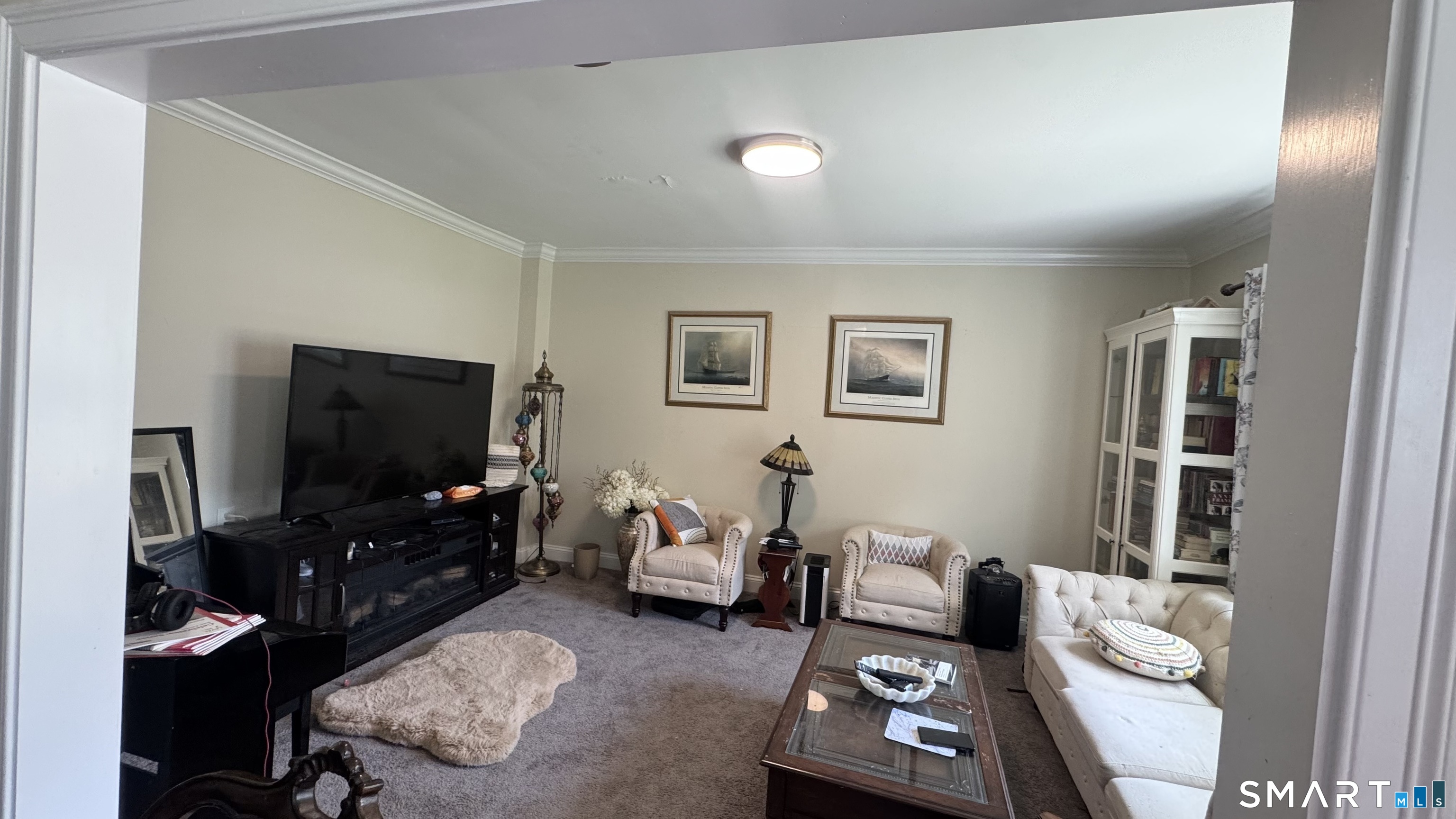 104 Prospect Street Ansonia, CT 06401 - Photo 32 of 40 a living room with furniture and a flat screen tv