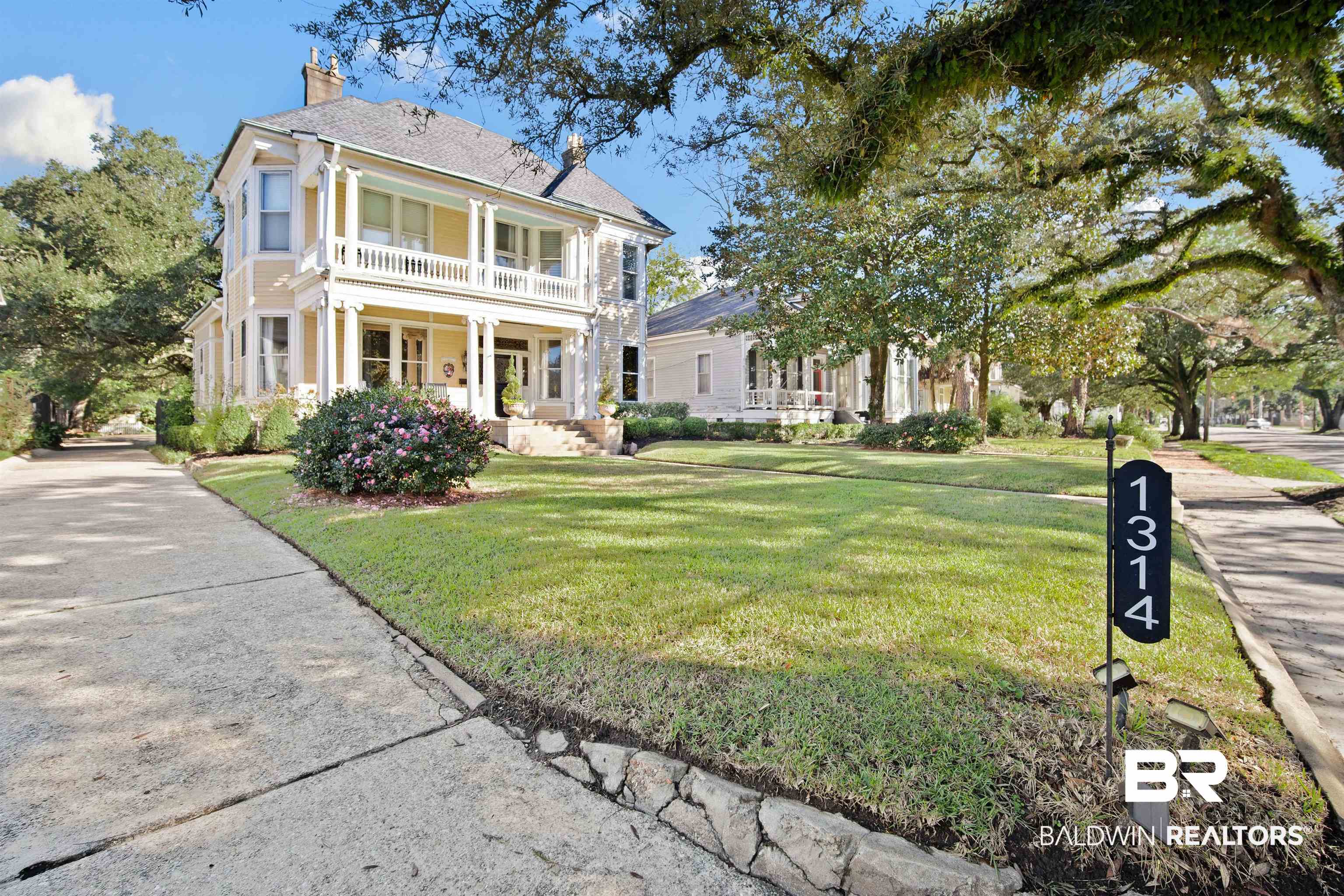 1314 Dauphin Street Mobile, AL 36604 - Photo 2 of 61 View of front of house featuring covered porch and a front yard