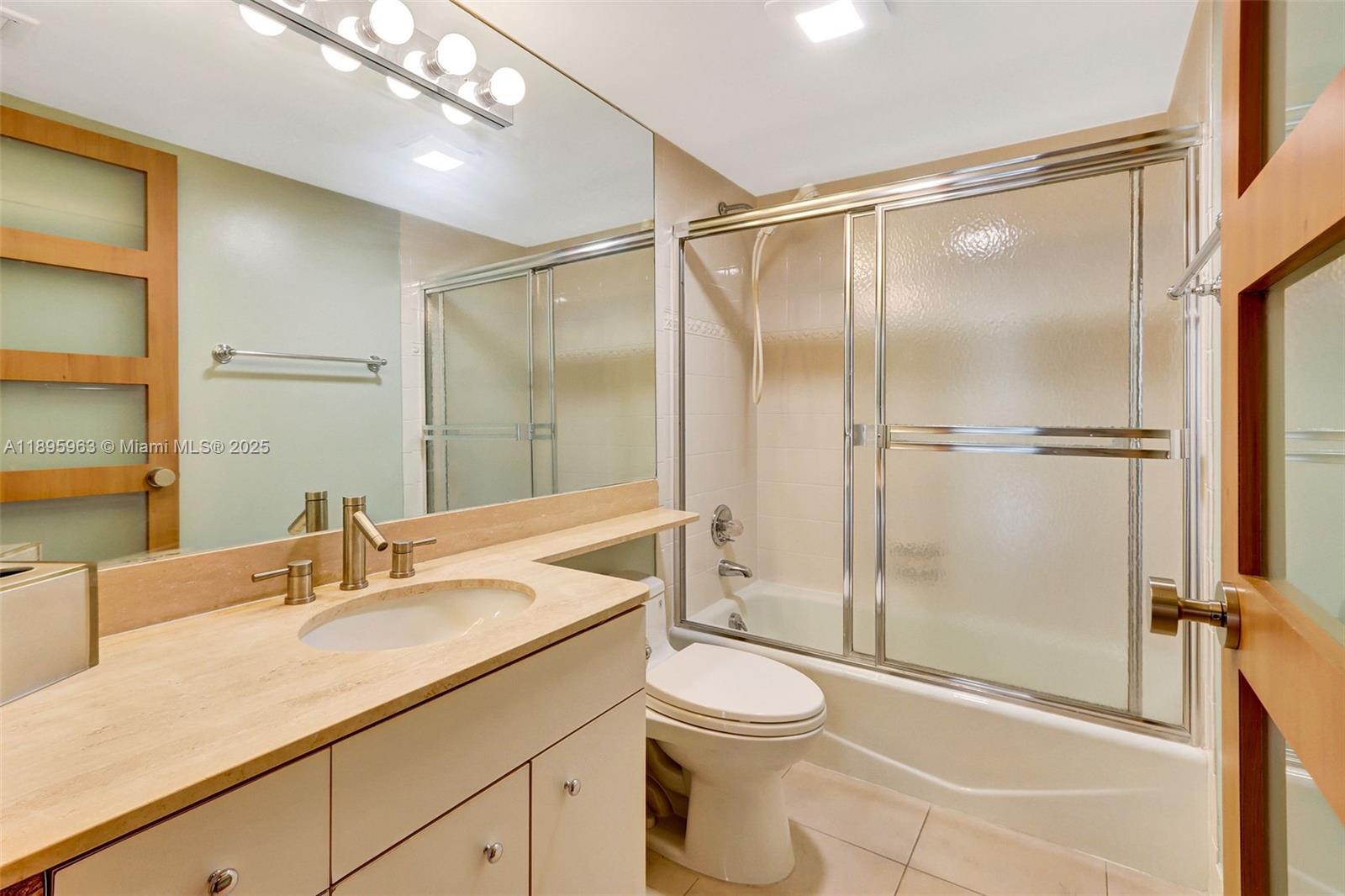 251 Crandon Boulevard, Unit 628 Key Biscayne, FL 33149 - Photo 18 of 32 a bathroom with a shower sink vanity mirror and toilet