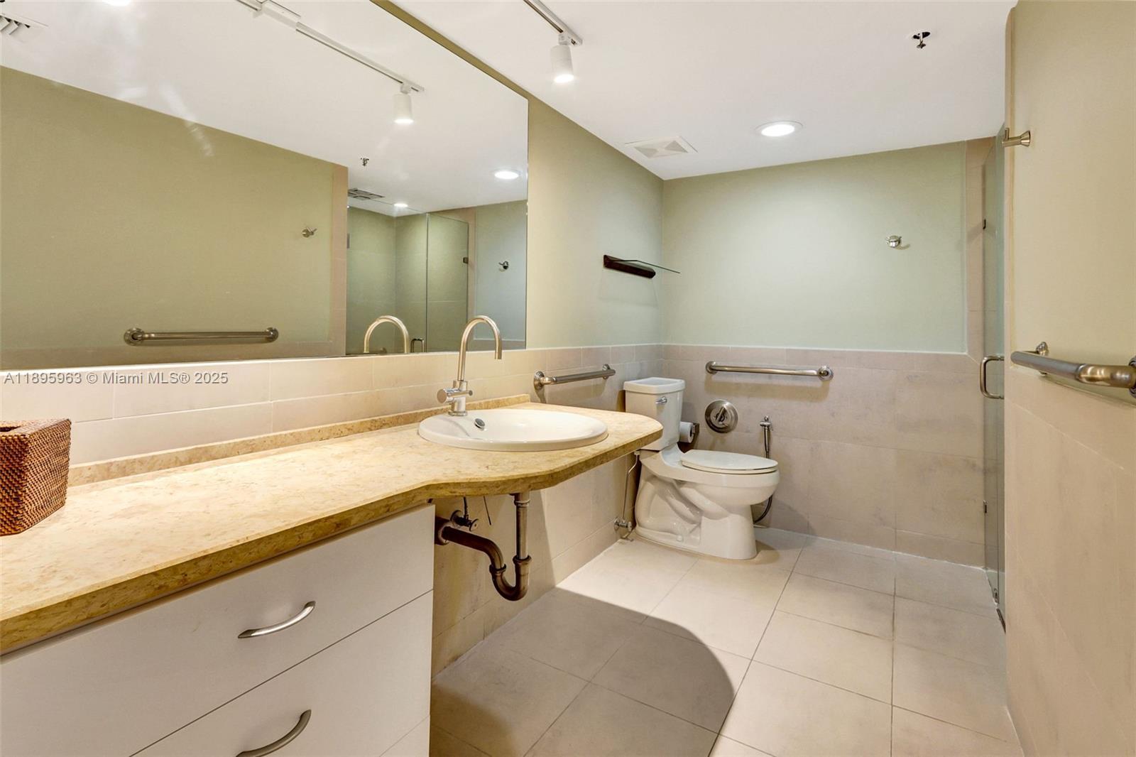 251 Crandon Boulevard, Unit 628 Key Biscayne, FL 33149 - Photo 21 of 32 a bathroom with a sink mirror and a toilet