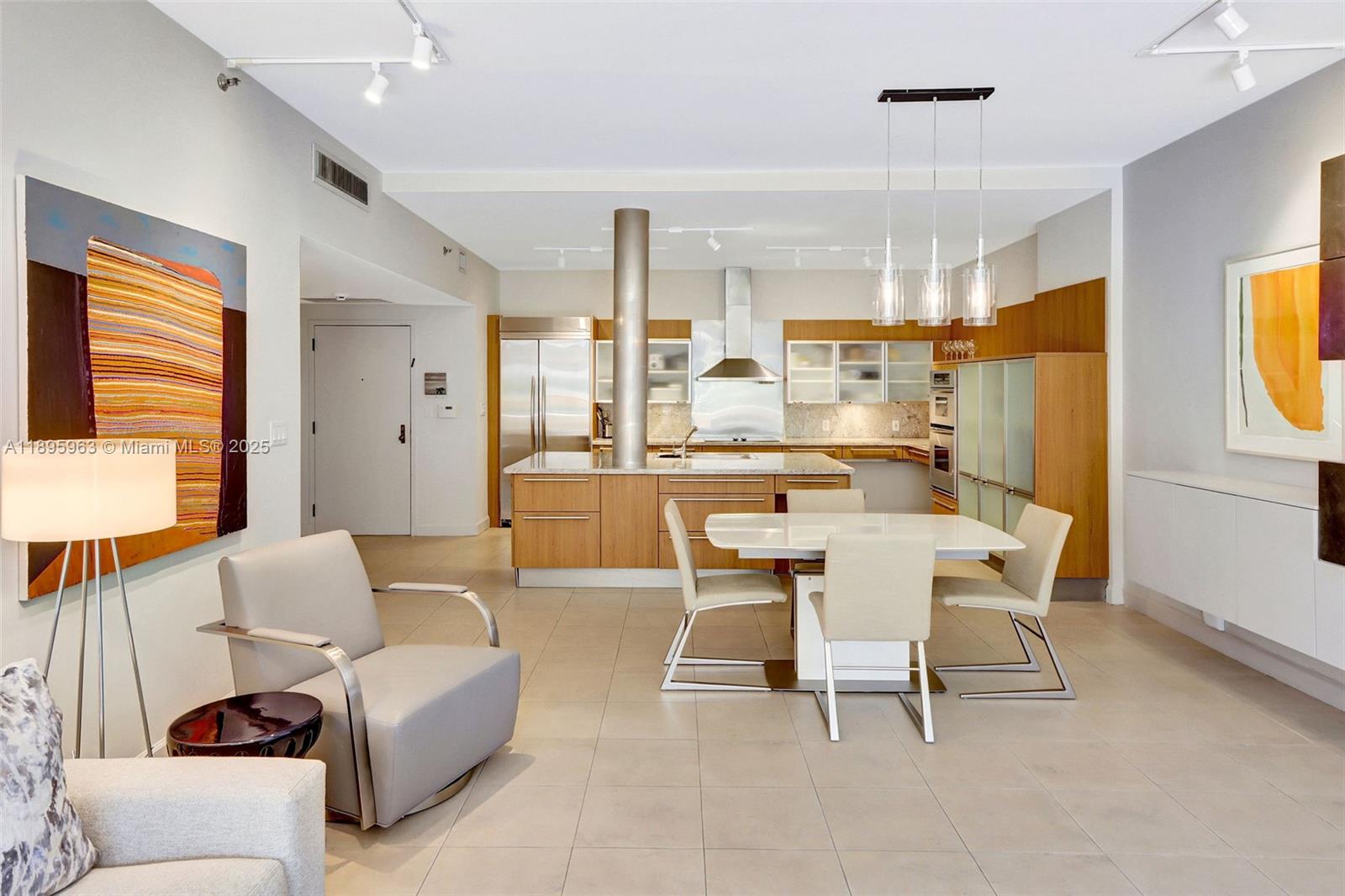 251 Crandon Boulevard, Unit 628 Key Biscayne, FL 33149 - Photo 5 of 32 a dining room with furniture and a large window