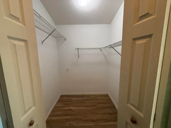 a view of wooden chairs and table in the patio