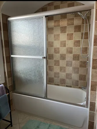 a bathroom with a bathtub and a shower