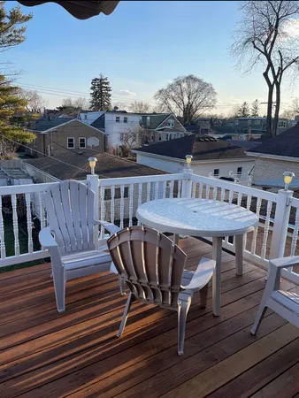 a view of a dinning table and chairs in the roof deck