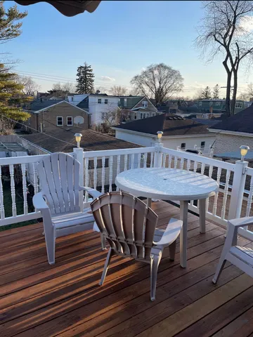 a view of a dinning table and chairs in the roof deck