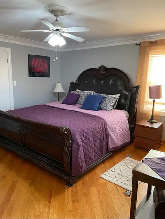 a bedroom with a bed and a chandelier
