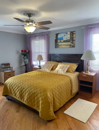 a bed sitting in a bedroom next to a window
