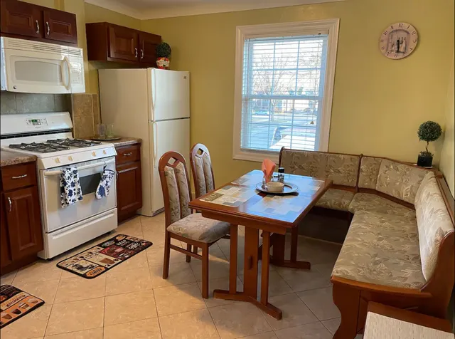 a living room with a table chairs and a window