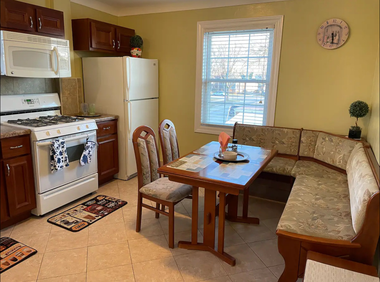 6101 West Fletcher Street, Unit 1 Chicago, IL 60634 - Photo 7 of 17 a living room with a table chairs and a window