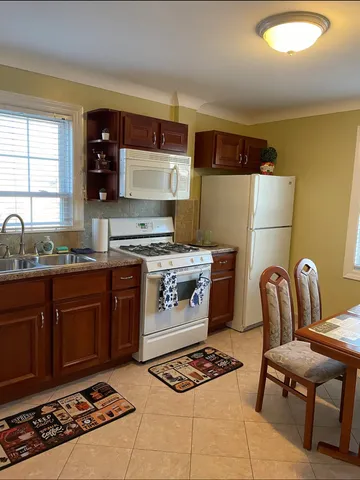 a kitchen with a stove a sink and a microwave