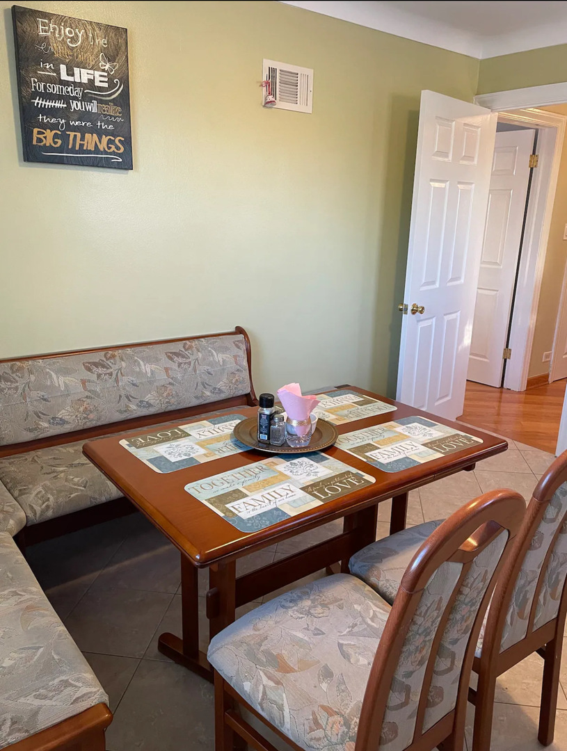 6101 West Fletcher Street, Unit 1 Chicago, IL 60634 - Photo 10 of 17 a bed sitting in a bedroom next to a window