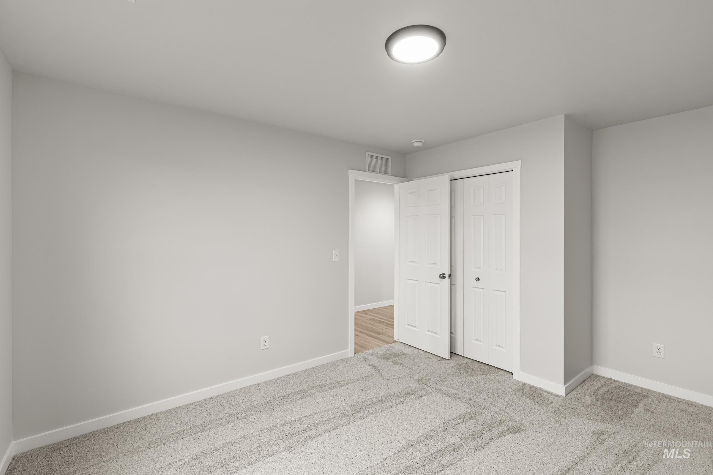 13693 Redway Court Caldwell, ID 83607 - Photo 10 of 25 Unfurnished bedroom featuring light colored carpet and a closet
