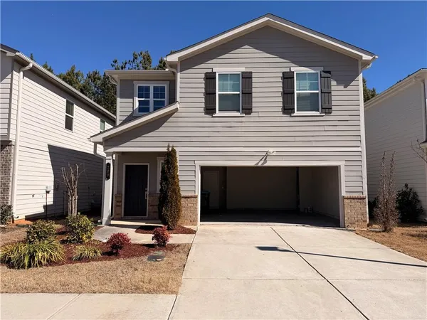 a front view of a house with a yard