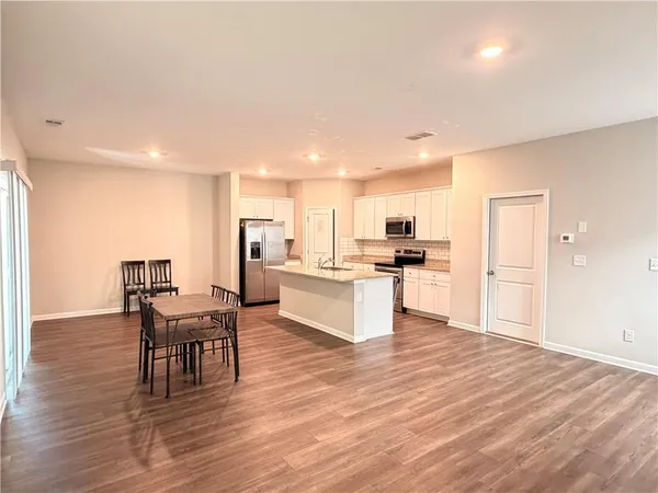 a kitchen with a table and chairs in it