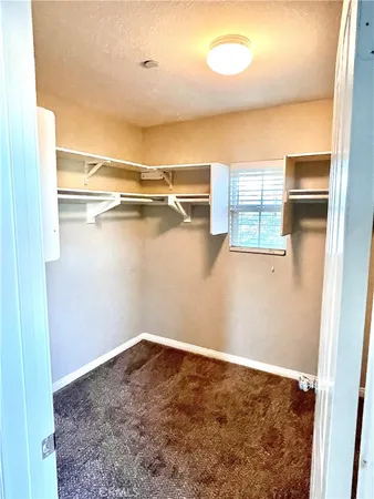 a view of a room with rack on the wall and a window