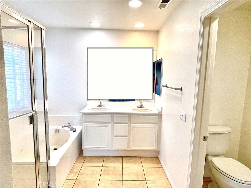 4473 Bigem Court Riverside, CA 92501 - Photo 10 of 18 a bathroom with a bathtub sink and toilet