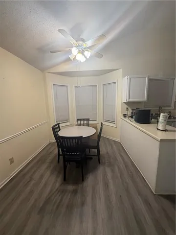 a dining room with furniture and wooden floor