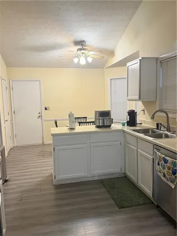 a kitchen with a sink cabinets and window