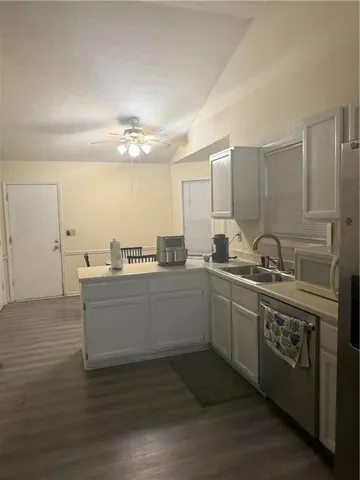 a kitchen with stainless steel appliances a stove top oven a sink and a refrigerator