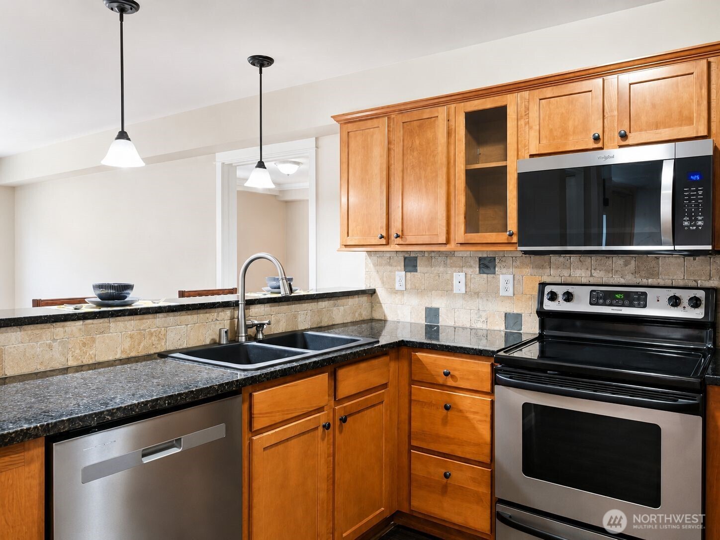 700 32nd Street, Unit A309 Bellingham, WA 98225 - Photo 4 of 28 a kitchen with stainless steel appliances granite countertop a stove and a microwave