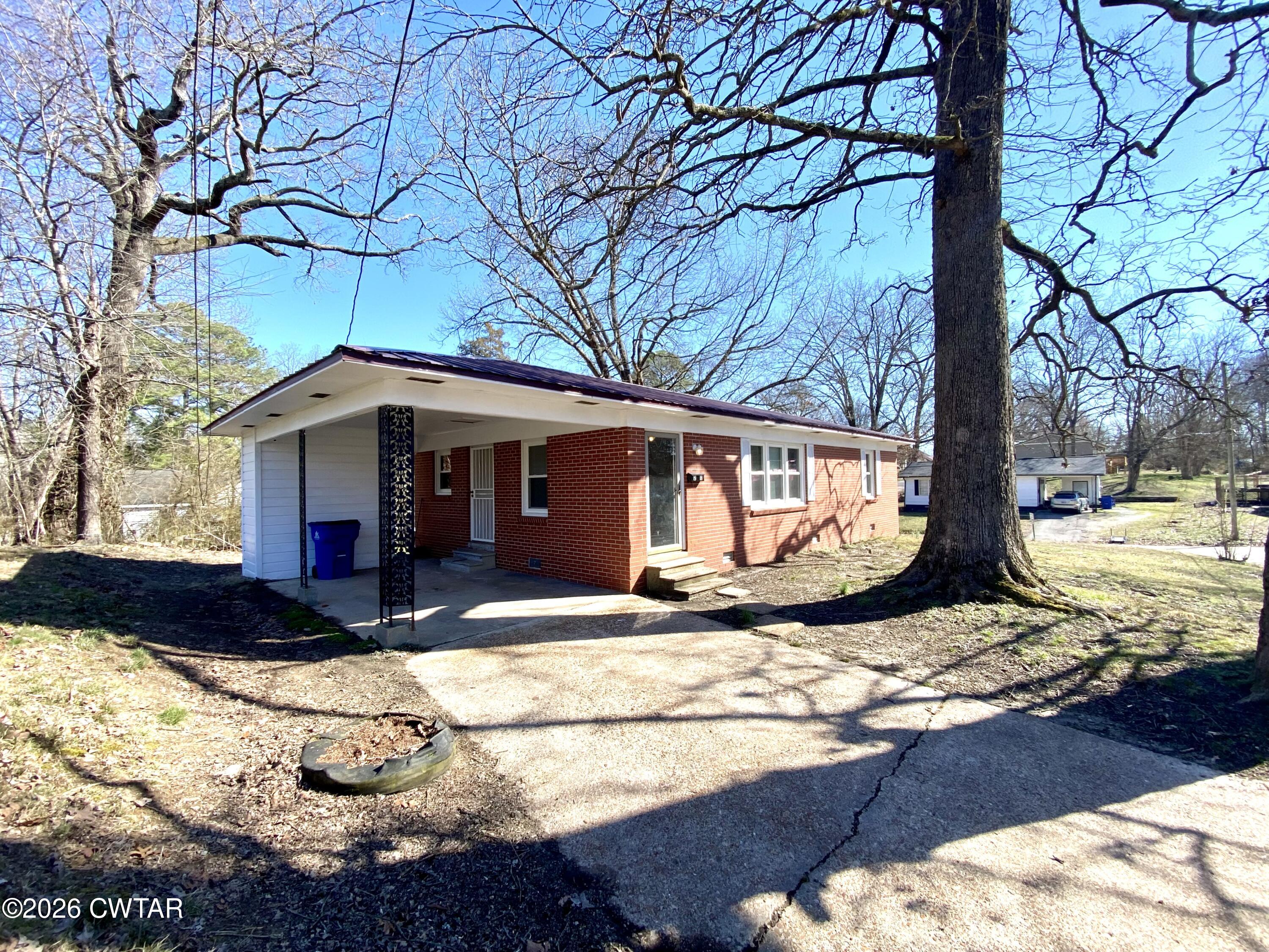 20 South Garland Street McKenzie, TN 38201 - Photo 1 of 18 a view of a white house with a large tree