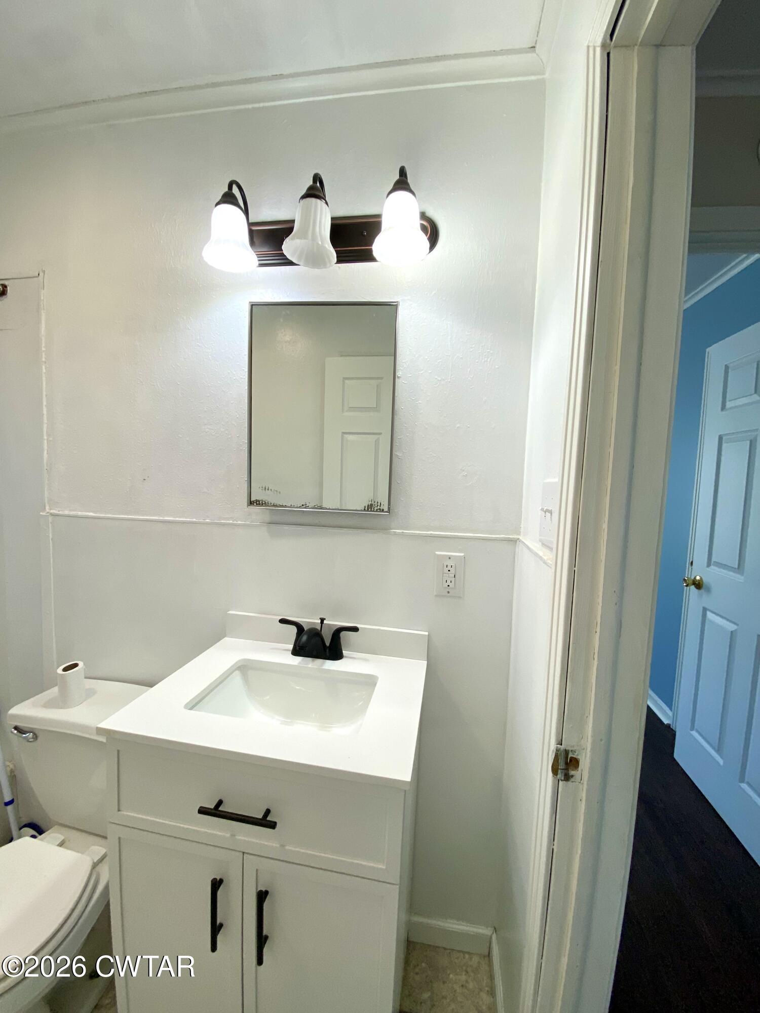 20 South Garland Street McKenzie, TN 38201 - Photo 15 of 18 a bathroom with a sink and mirror