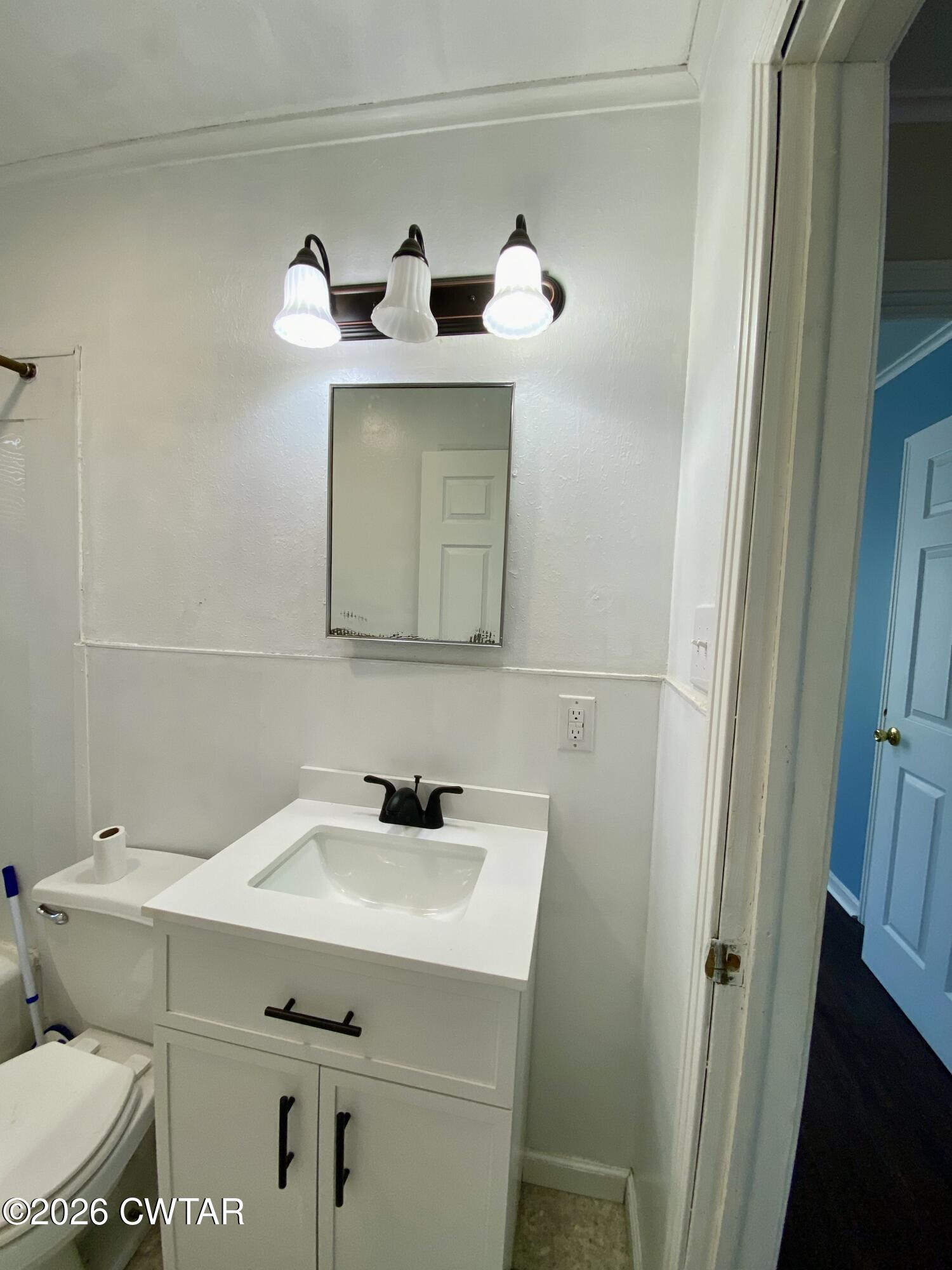 20 South Garland Street McKenzie, TN 38201 - Photo 16 of 18 a bathroom with a sink and a mirror