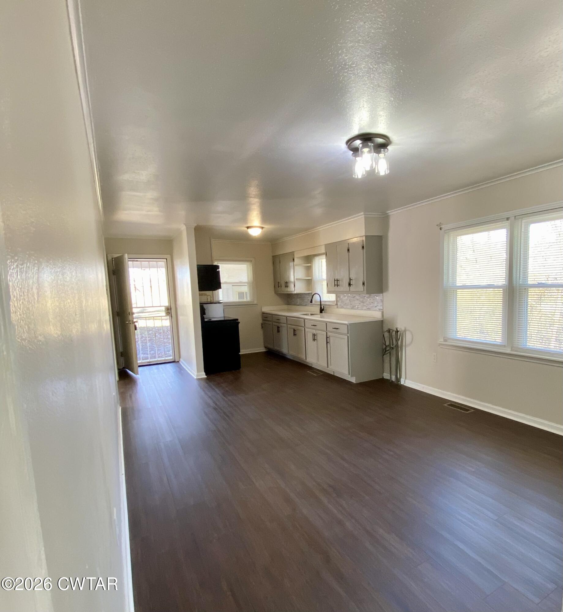 20 South Garland Street McKenzie, TN 38201 - Photo 6 of 18 a view of a living room with hardwood floor and a kitchen