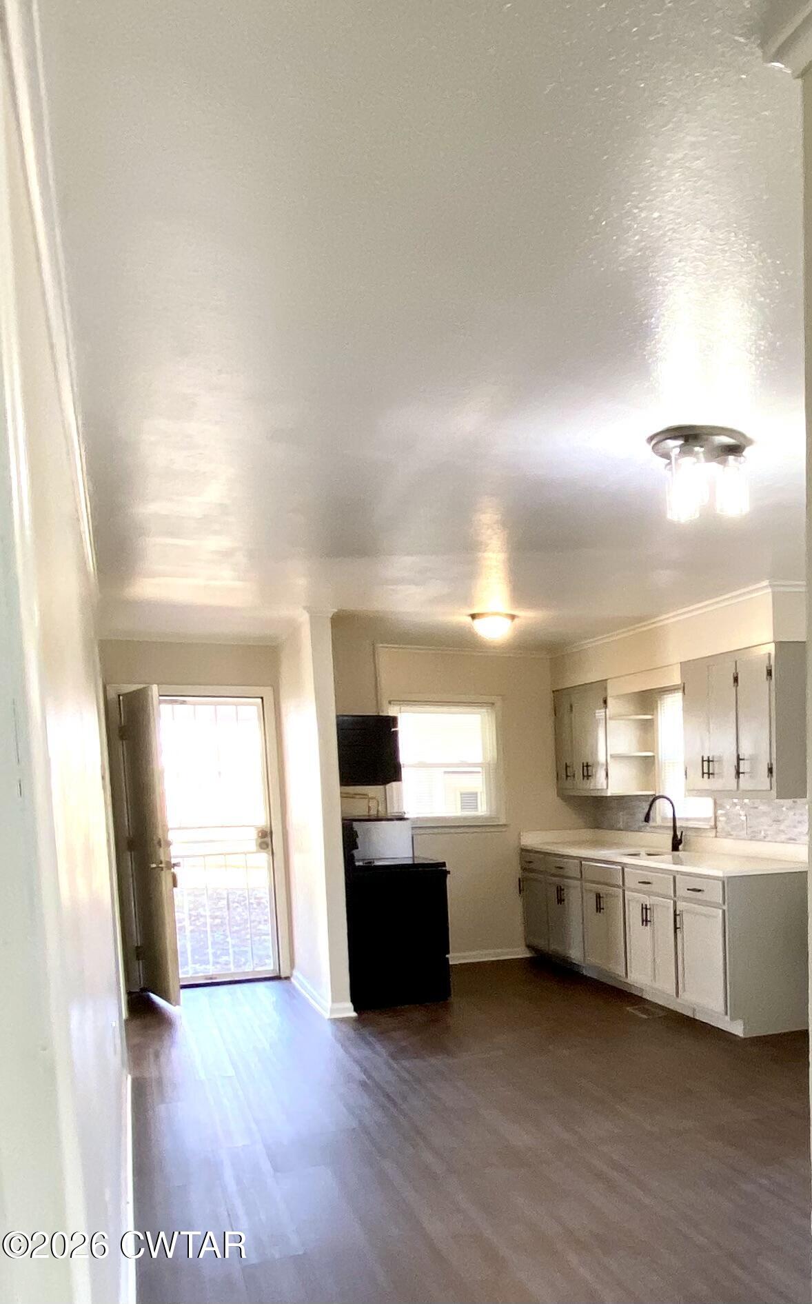 20 South Garland Street McKenzie, TN 38201 - Photo 7 of 18 a view of a kitchen with a sink stove cabinets and a kitchen