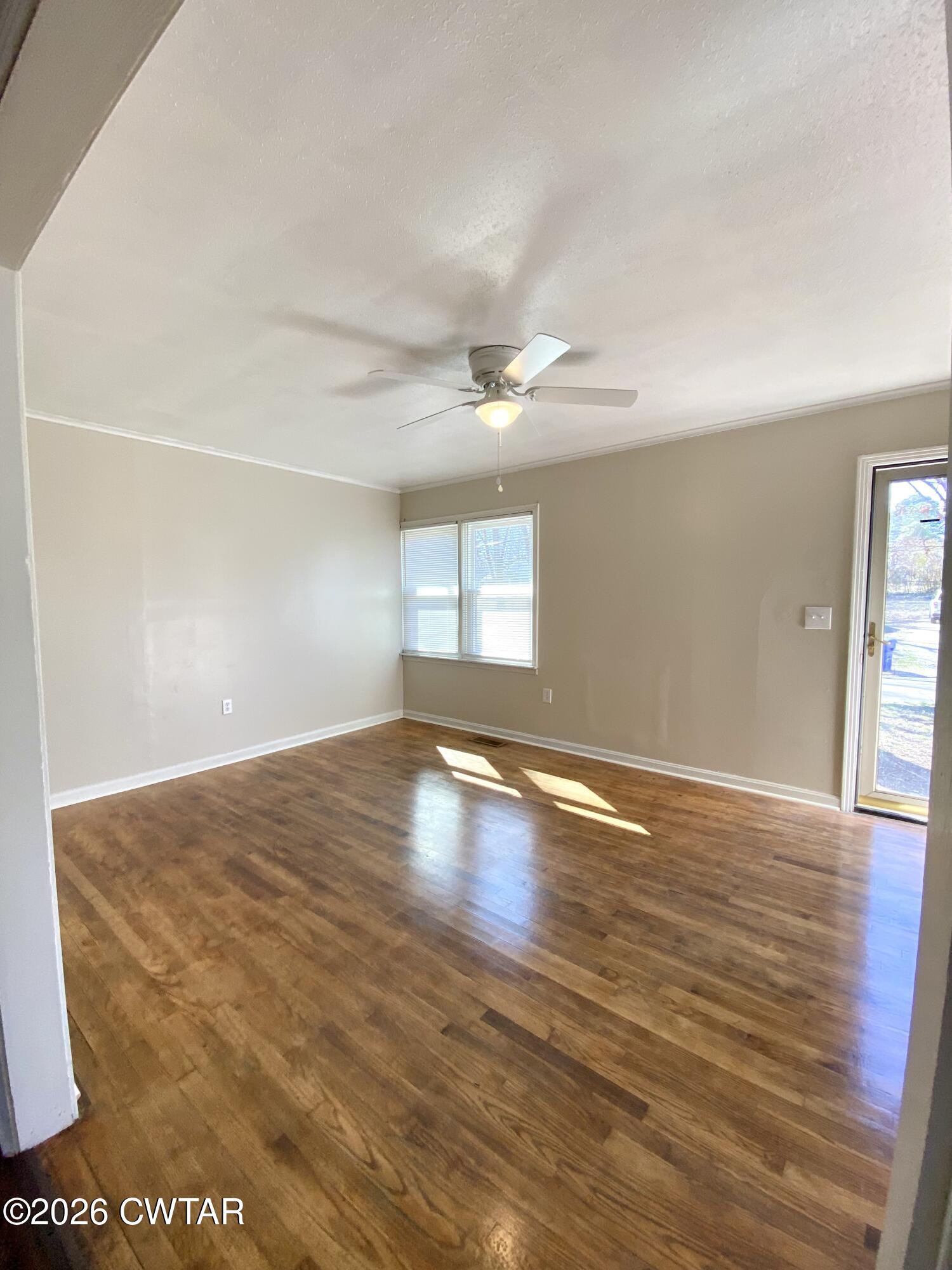 20 South Garland Street McKenzie, TN 38201 - Photo 8 of 18 an empty room with wooden floor and windows