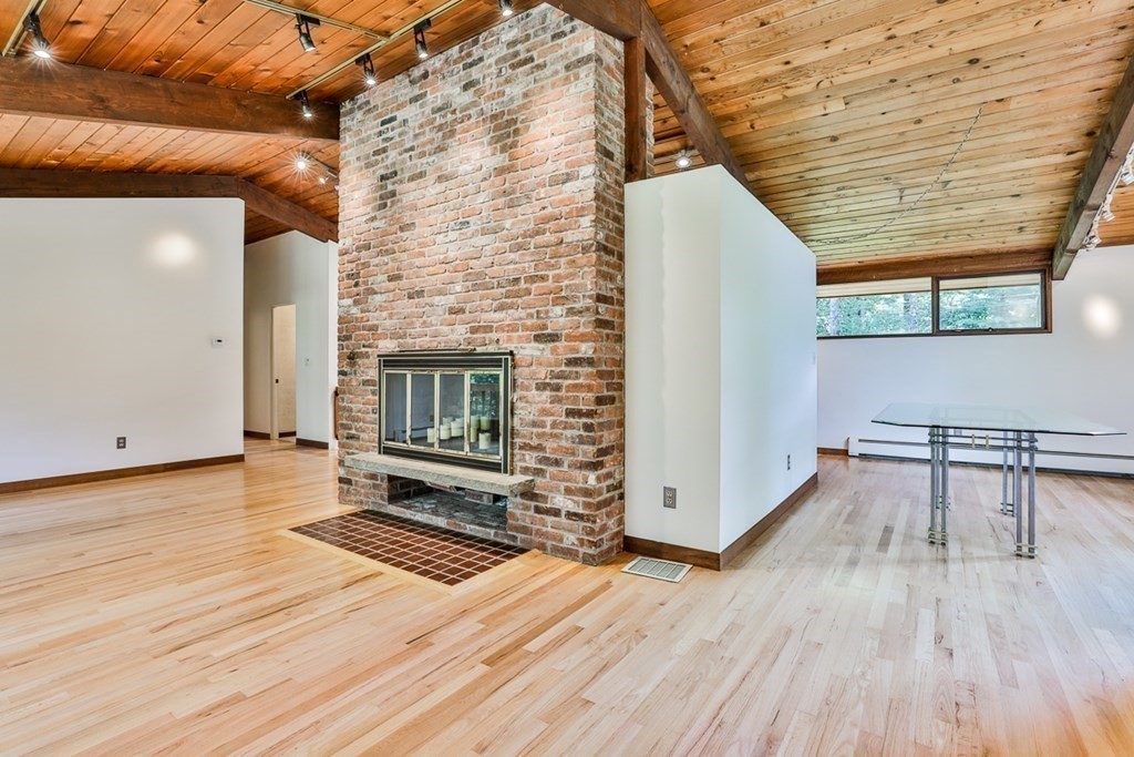 62 Woodside Road Harvard, MA 01451 - Photo 13 of 36 a view of a living room a wooden floor and a fireplace