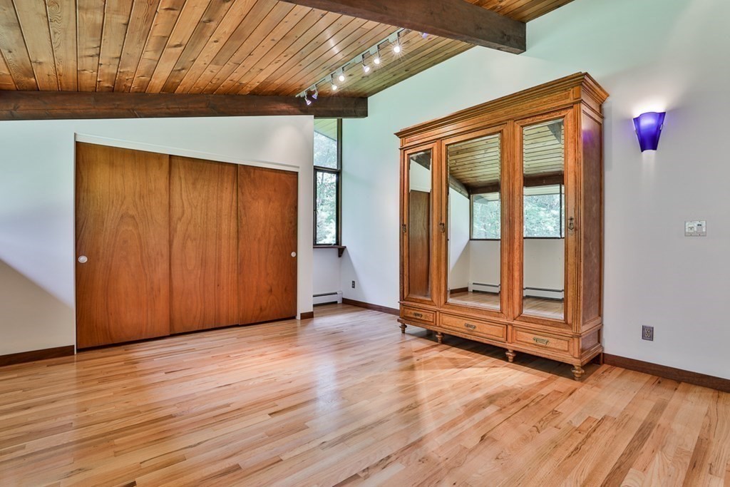 62 Woodside Road Harvard, MA 01451 - Photo 21 of 36 an empty room with wooden floor and door