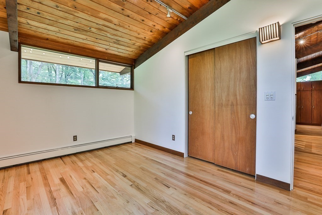 62 Woodside Road Harvard, MA 01451 - Photo 24 of 36 a view of empty room with wooden floor and fan