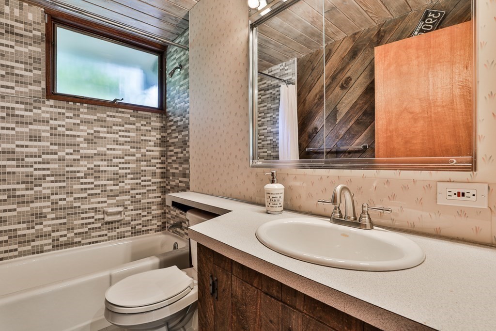 62 Woodside Road Harvard, MA 01451 - Photo 32 of 36 a bathroom with a granite countertop toilet sink and mirror