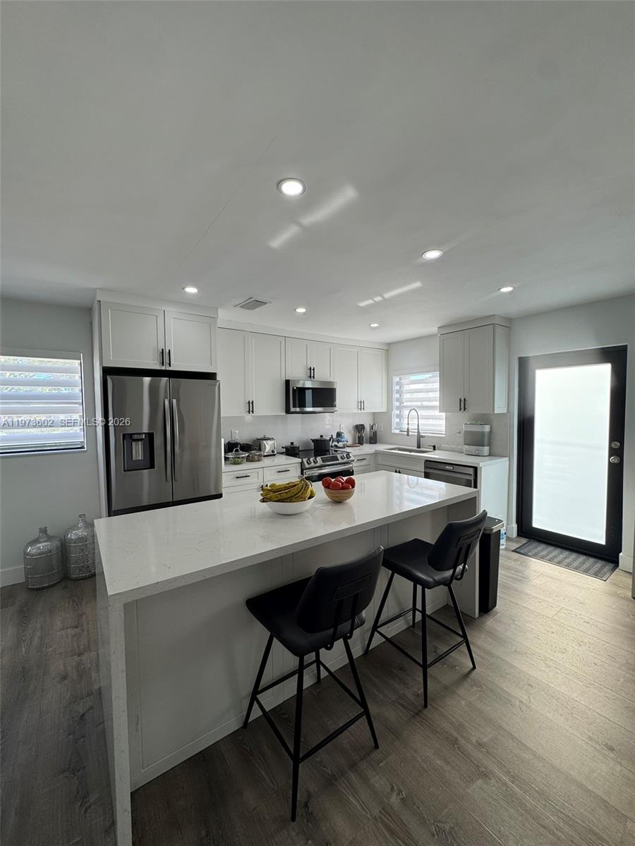 12534 Southwest 27th Street Miami, FL 33175 - Photo 12 of 49 a kitchen with a dining table chairs and refrigerator